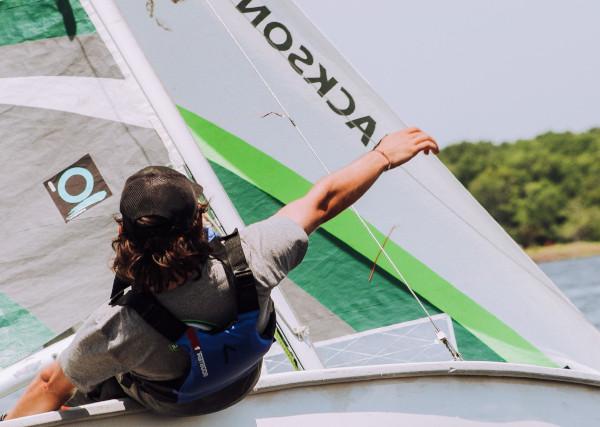 a young person steering a sailing boat